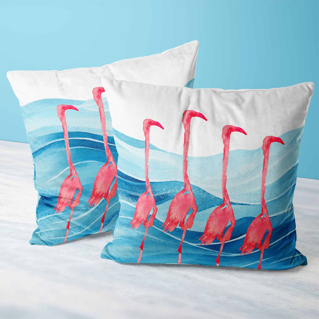 Square pillow displayed on a sofa, showcasing its tropical flamingo and ocean wave design, perfect for modern beach house decor.