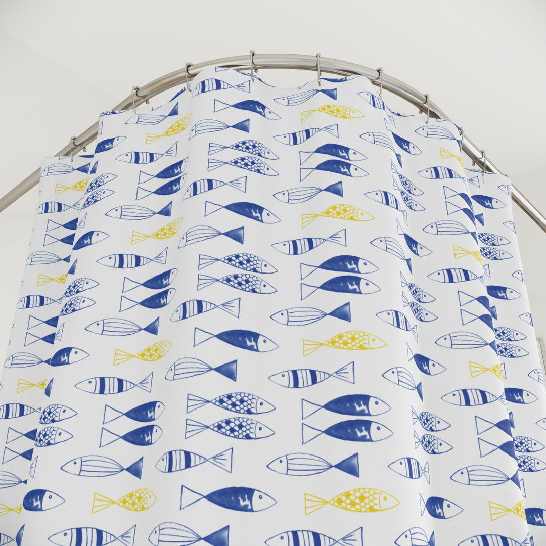 Bright and cheerful shower curtain featuring a repeating pattern of blue and yellow fish on a white background. The fish are styled with simple, geometric designs, adding a playful and modern touch to the decor.