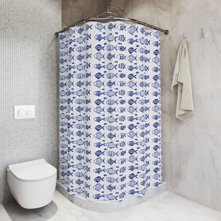 Blue and white fish-pattern shower curtain styled in a sleek, tiled bathroom with a neutral color palette and modern fixtures.