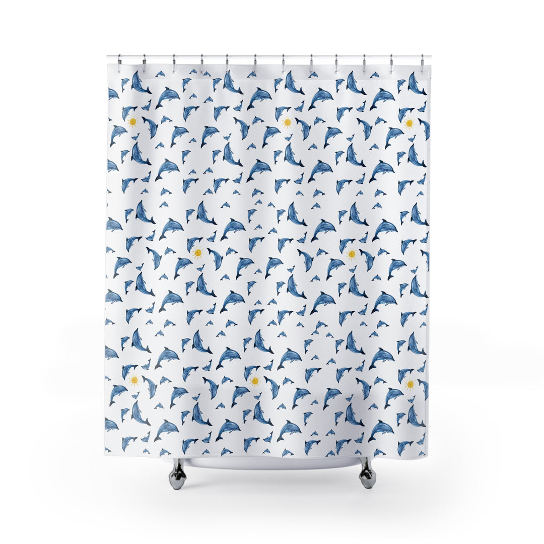 Dolphin shower curtain featuring playful blue dolphins and yellow suns on a white background, hung on a curved rod in a modern bathroom.