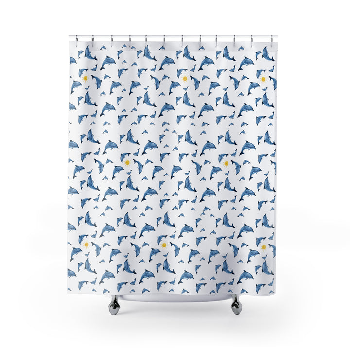 Dolphin shower curtain featuring playful blue dolphins and yellow suns on a white background, hung on a curved rod in a modern bathroom.
