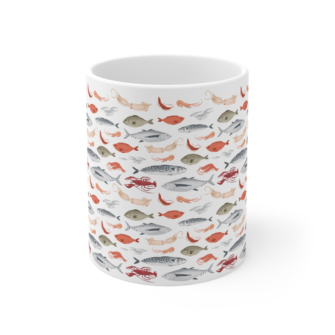 White ceramic mug with seafood pattern, featuring fish, squid, and lobster
