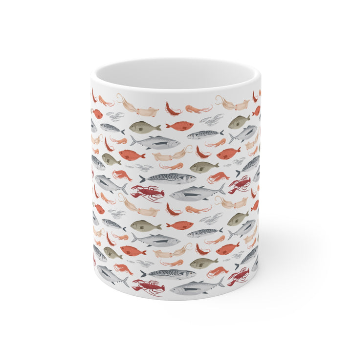 White ceramic mug with seafood pattern, featuring fish, squid, and lobster