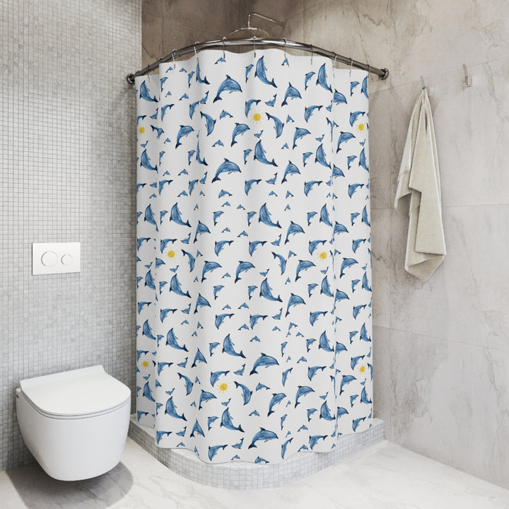 Shower curtain with a playful design of blue dolphins and yellow suns hanging in a modern bathroom with a freestanding tub, minimal decor, and soft natural lighting.