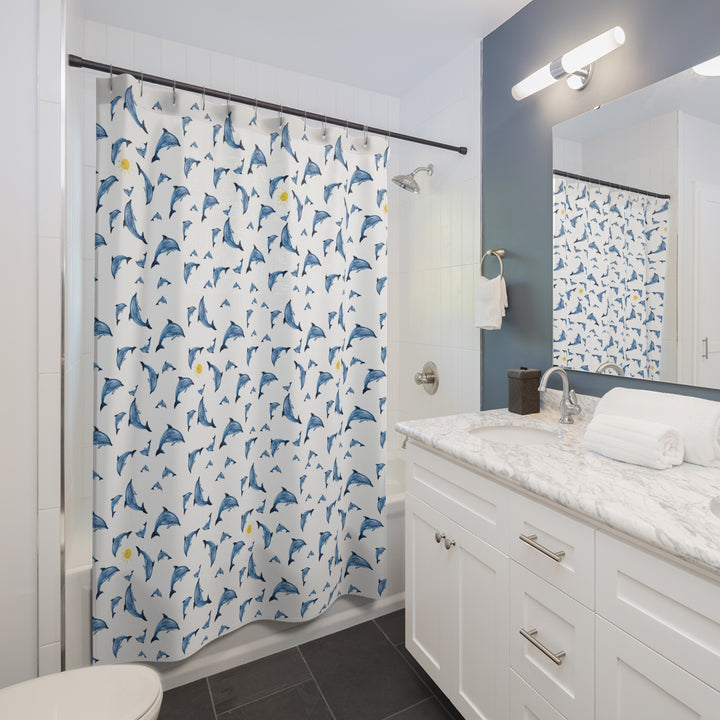 Bright and cheerful dolphin shower curtain displayed in a contemporary bathroom with a marble countertop, navy accent wall, and white cabinetry, adding a whimsical marine touch to the space.
