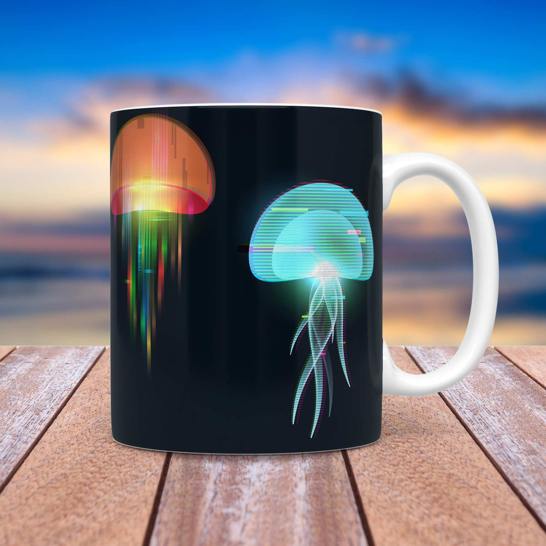 A black ceramic mug featuring a futuristic jellyfish design with neon, glitch-style effects in blue, green, and orange. The mug is placed on a wooden surface with a serene beach sunset in the background, where warm hues of orange and blue blend over the ocean horizon.