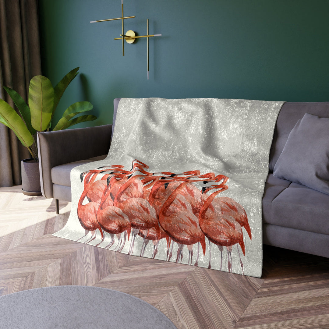Flamingo Velvet Blanket draped over a couch in a living room