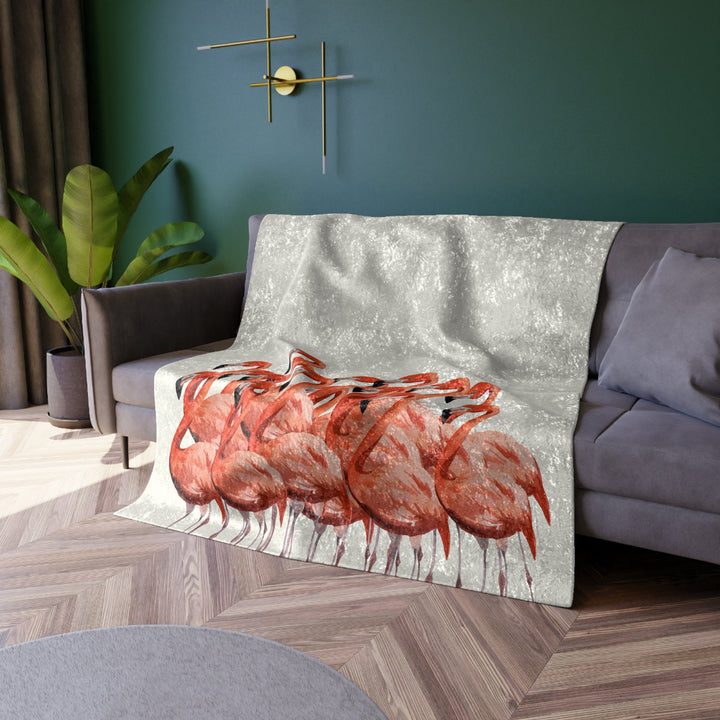 Flamingo Velvet Blanket draped over a couch in a living room